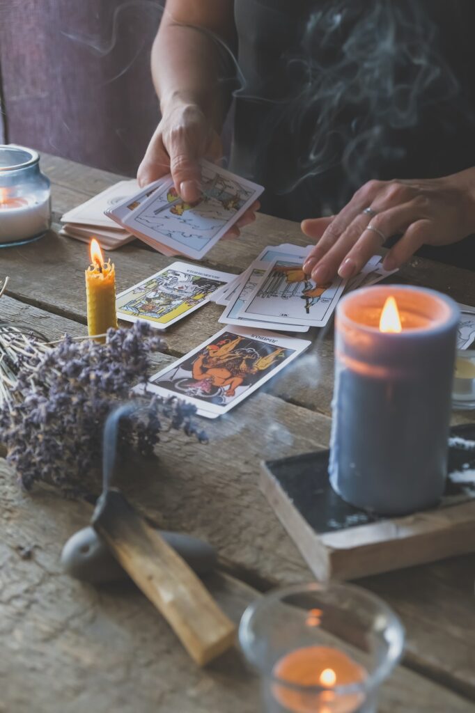 Tarot cards, Fortune telling on tarot cards at night by candlelight, magic crystal, occultism